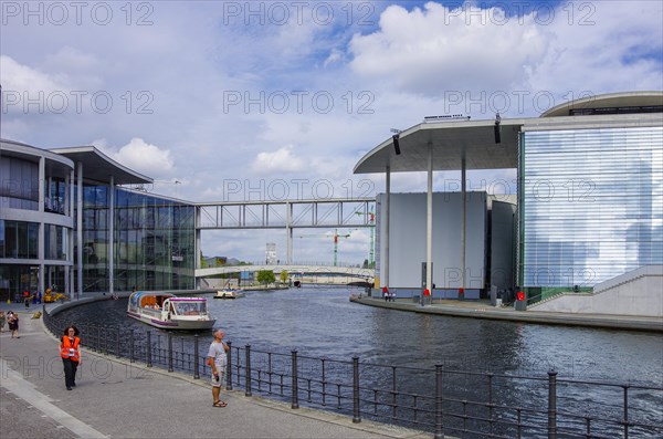 Excursion boat full of tourists on the Spree between Paul-Loebe- and Marie-Elisabeth-Lueders-Haus