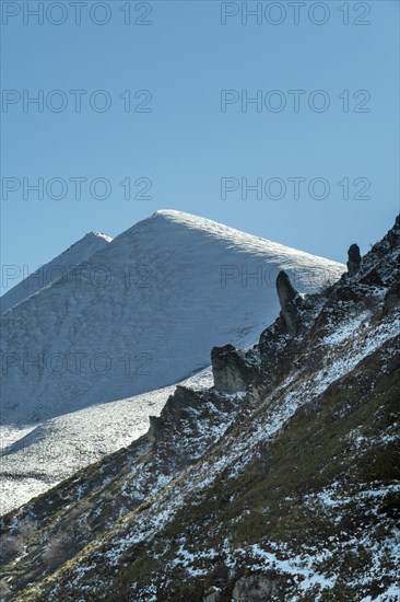 Regional natural park of the Volcanoes of Auvergne. Parc naturel regional des Volcans d'Auvergne. Puy de Monne and Puy Barbier in the background at the cross Morand pass. Puy de Dome department. Auvergne-Rhone-Alpes. France