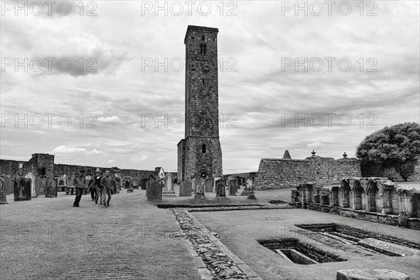 Tourists in front of ruined cathedral