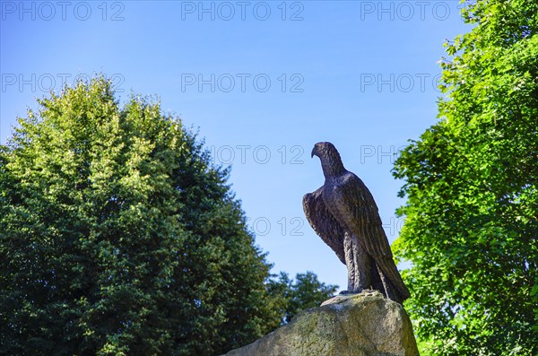 Eagle sculpture on stone pedestal