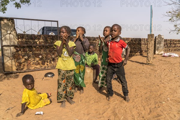 A group of African children singing and playing