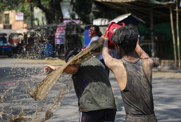 Revellers palying mud to celebrate Holi