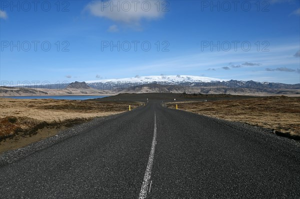 Road to the small peninsula of Dyrholaey on the south coast with a view of the glacier Myrdalsjoekull