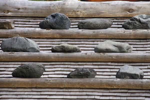 Stone weighed roof of a wooden house at Narai-juku traditional small town in Nagano