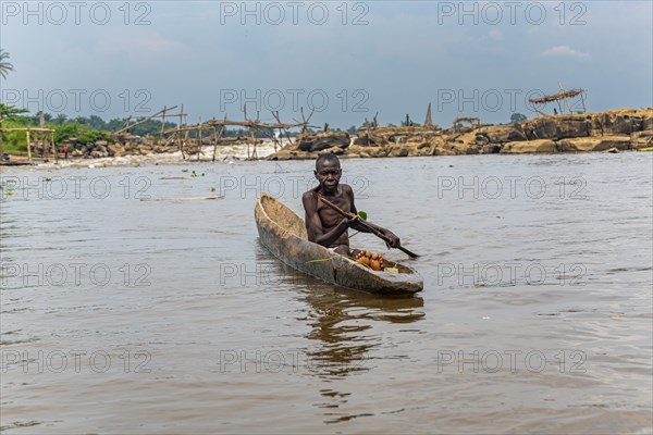 Fisherman in his dugout canoe