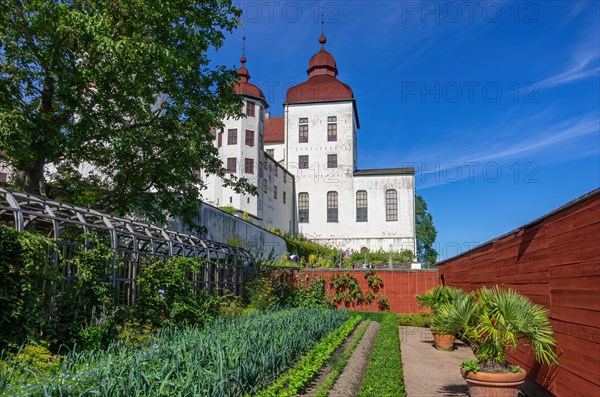 View of castle garden and baroque Laeckoe Castle on Kallandsoe in Vaenern in Vaestergoetland