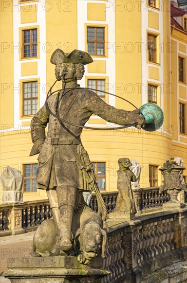Baroque statue of a hunter with dog in front of the main entrance