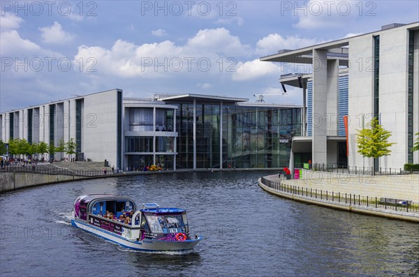 Excursion boat full of tourists on the Spree between Paul-Loebe- and Marie-Elisabeth-Lueders-Haus