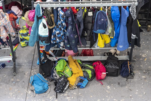 School bags and jackets discarded by school children on the floor