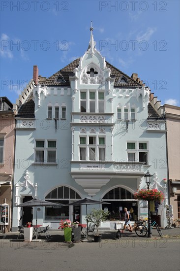 White building with bay window in main street