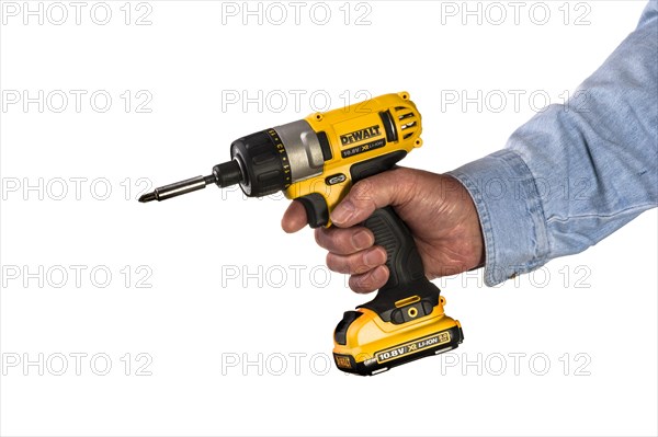 Man in denim shirt holding a DeWalt electric screwdriver. 10.8 volt DeWalt with rechargeable LI-ION battery