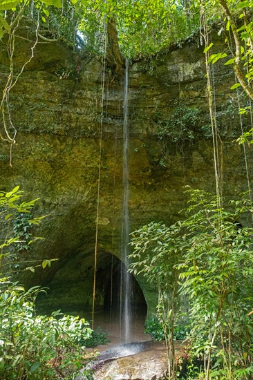 Waterfall at the limestone caves of Gruta da Judeia in the jungle