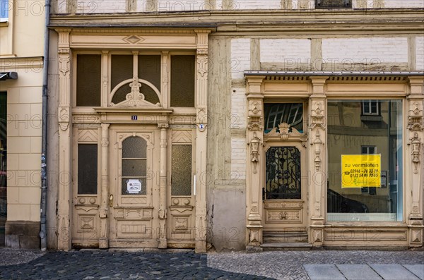 Front gate and shop window of the heritage-protected building Poelkenstrasse 11 in the historic Neustadt that is available for rent at the time of the photograph
