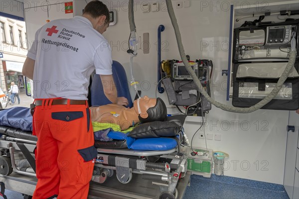 DRK staff in the ambulance Ambulance with dummy as demonstration