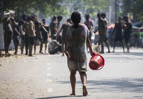 Revellers palying mud to celebrate Holi