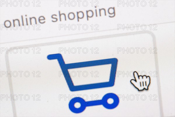 Symbol photo on the subject of online shopping. The symbol of a shopping cart and a mouse pointer can be seen on the display of a computer. Berlin