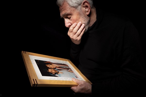 Senior grieving man. Remembering a departed loved one. Male experiencing loss and loneliness