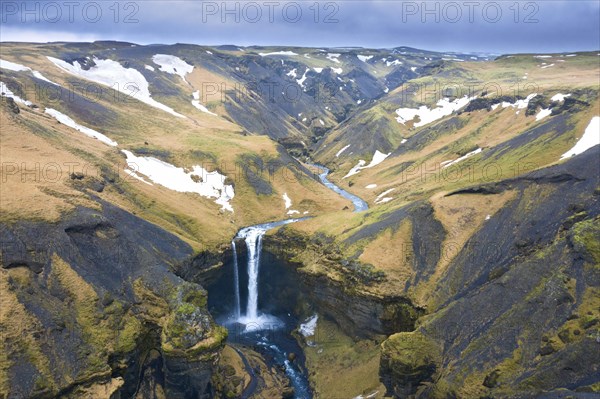 Aerial view over the Kvernufoss waterfall on the Kverna river in winter near Skogar