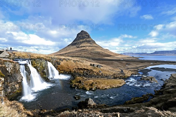 Kirkjufellsfoss waterfall and Kirkjufell mountain on the north coast of the Snaefellsnes peninsula in western Iceland