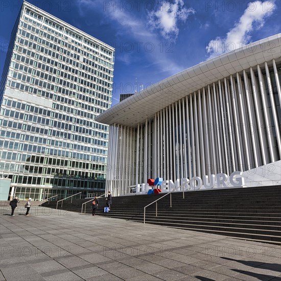 Tourists in front of Philharmonie Luxembourg with lettering