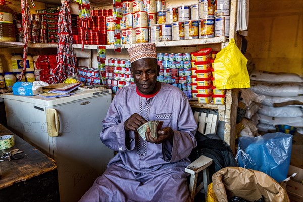 Local money changer in the Market in Dalaba