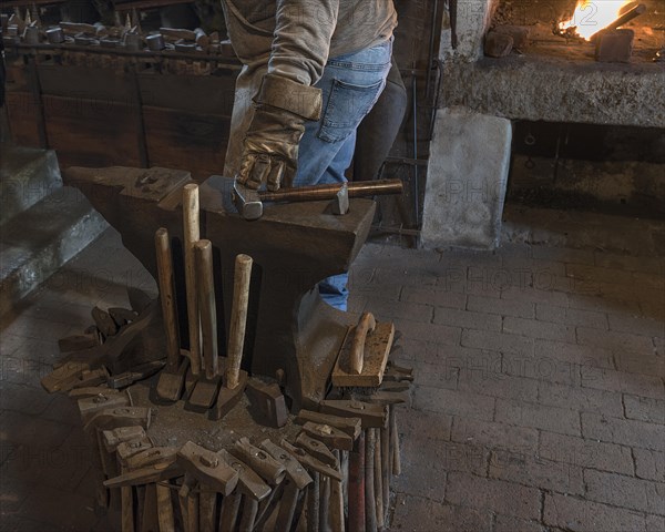 Anvil with forging hammers in a historic hammer mill from the 19th century