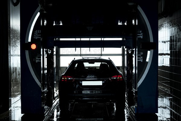 Car in Automatic Car Wash Machine in a Sunny Day in Switzerland