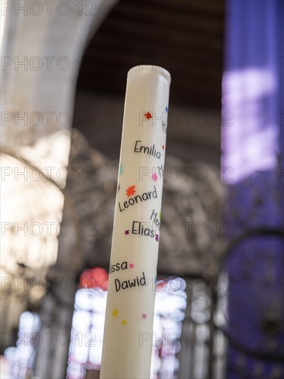 Candle with the names of the First Communion children in the chancel of the Minster of St. Mary and St. Mark