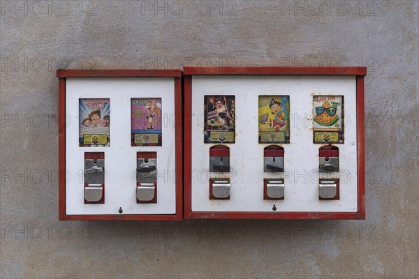 Chewing gum vending machines from the 1950s on a house wall