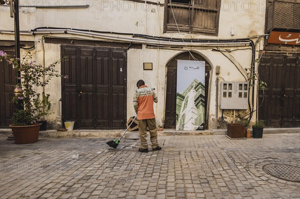 A man sweeps in the old city of Jeddah