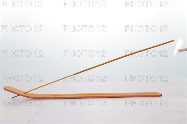 Close-up of an incense stick isolated on a white background