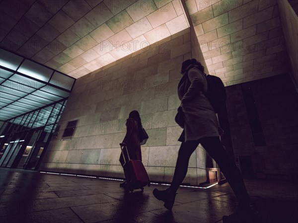 Silhouette of people on night city street