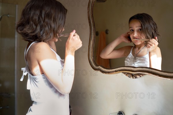 Girl brushing her teeth at home in the morning. Children's dental hygiene