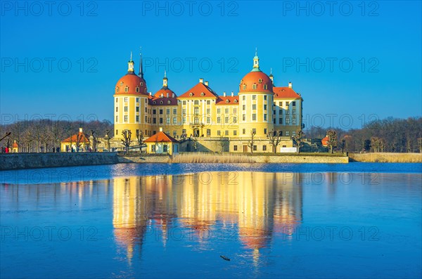 Exterior view of Moritzburg Castle in winter with half-frozen castle pond from the south