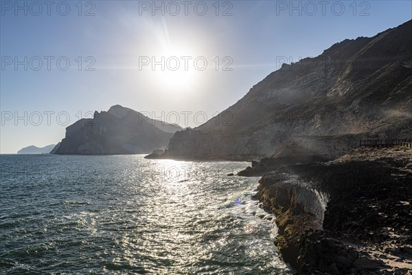 Backlight of the rugged cliffs north of Mughsail beach