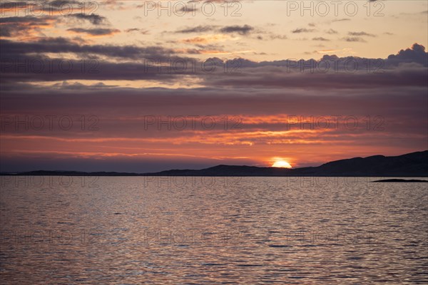 Dramatic sunset over the sea with archipelago island