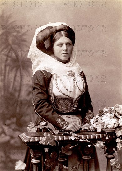 Studio portrait of a woman in traditional Greek dress