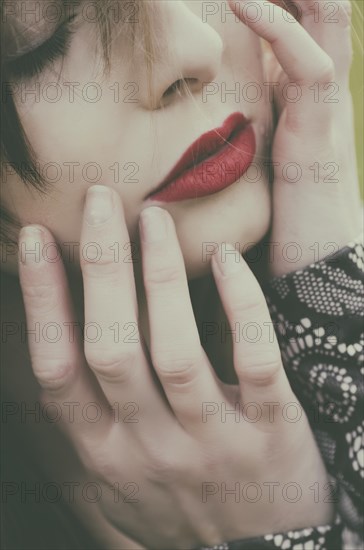 Beautiful young woman hands touching face