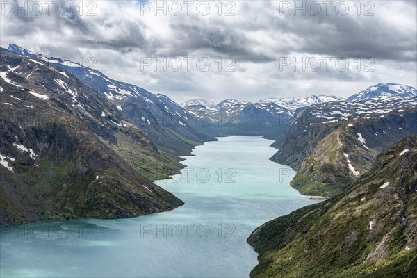 View of Lake Gjende and snowy mountains