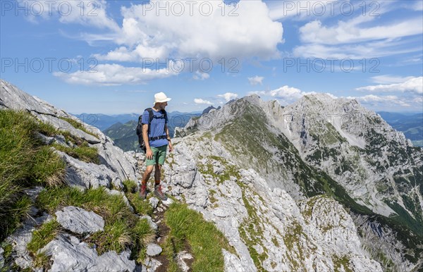 Mountaineer on a narrow ridge path