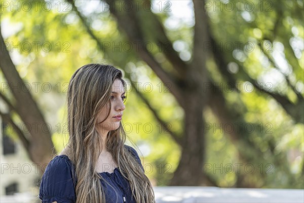 Thoughtful blond young woman with a lost look