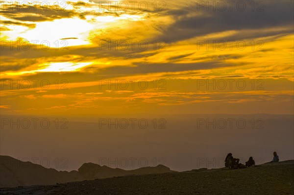 People enjoying the sunset from Ed Deir