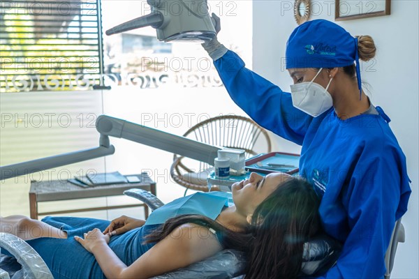 Young woman having her teeth checked during appointment at dentist's office