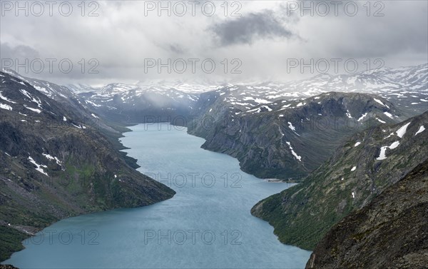 View of Lake Gjende and snowy mountains