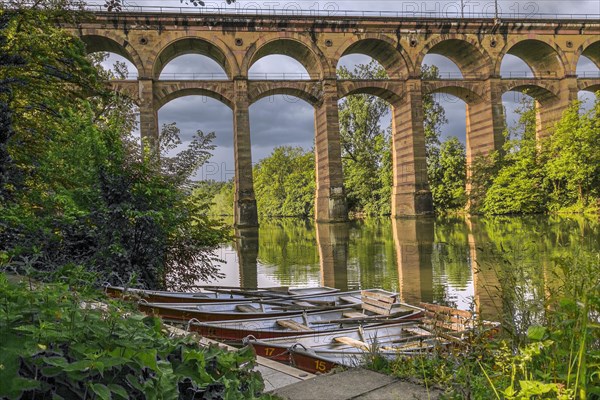 The railway viaduct Enzviaduct over the river Enz in the foreground floating boats in the town of Bietigheim-Bissingen