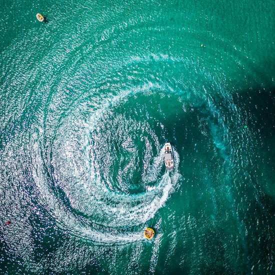 Aerial view on motorboat and jetski on the sea surface