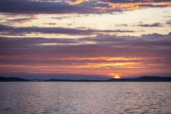 Dramatic sunset over the sea with archipelago island