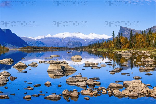 Scenic view at Lake Laitaure in rapa valley at Sareks national park with and snow capped mountains and autumn colors