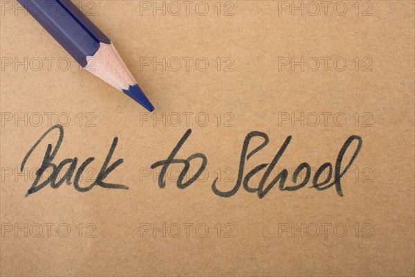 Color pencil and back to school title on a notebook