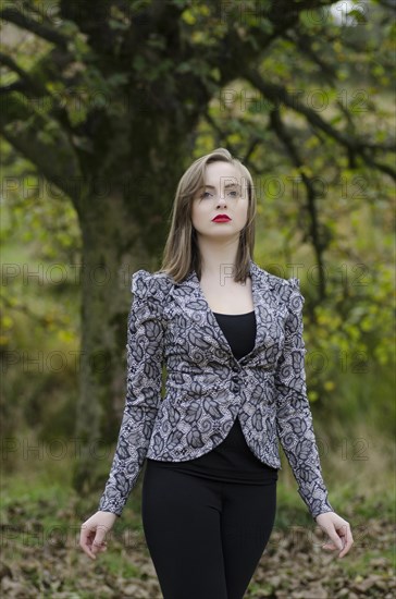 Beautiful young woman standing in the countryside